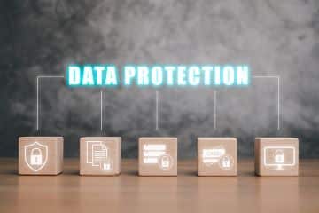 A lineup of wooden blocks on a desk, each with a different lock icon, and the words "Data Protection" floating above.