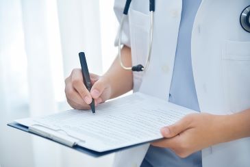 Doctor taking note on checklist paper